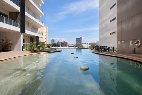 a swimming pool in the middle of a building at Above & Beyond (21st floor two bedrooms apartment) in Darwin