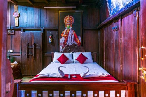 a bedroom with a bed with red pillows at Castillo De Woods , The Private Luxury Villa , 8 BHK, Vattavada in Kottakamboor
