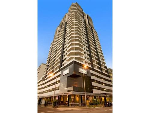 a tall building with a street light in front of it at Above & Beyond (21st floor two bedrooms apartment) in Darwin