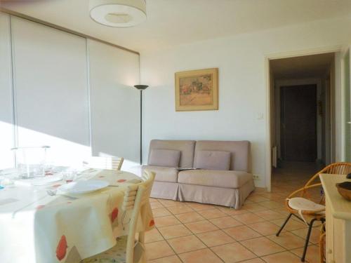 un salon avec une table et un canapé dans l'établissement Appartement 2 pièces, terrasse, proche plage et centre, Le Lavandou - FR-1-251-345, au Lavandou