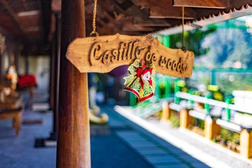 a wooden sign that reads castle die roosteers hanging in a store at Castillo De Woods , The Private Luxury Villa , 8 BHK, Vattavada in Kottakamboor