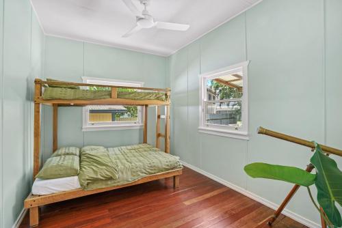 a bedroom with a bunk bed and a window at Dougys Beach Shack in Kingscliff