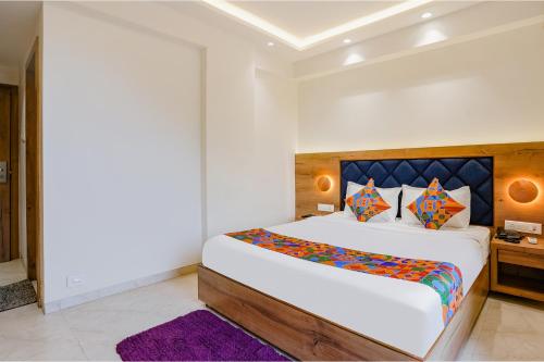 a bedroom with a large bed and a purple rug at FabHotel Pancharatna Regency in Pune