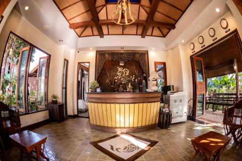 a large room with a bar in a house at Khammon Lanna Resort Chiang Mai in Chiang Mai