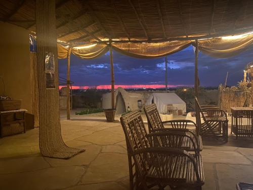a patio with chairs and a table with a view at Grand Siwa in Siwa