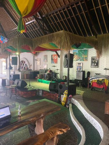 a room with a stage with a table and speakers at PACA'S Reggae Bar & Hostel in Ambat