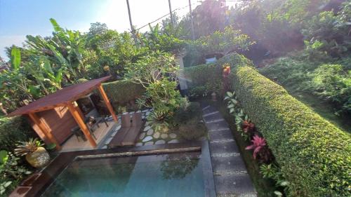an image of a garden with a swimming pool at Ubud Paradise Villa in Ubud