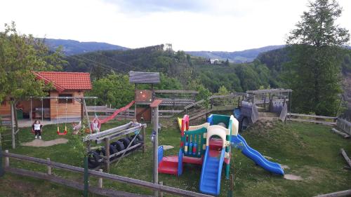a park with a playground with a slide and slidesktop at Biohof Laibacher in Stubenberg