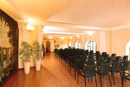 a room with a bunch of chairs in it at Hotel La Nuova Rotaia in Gallarate