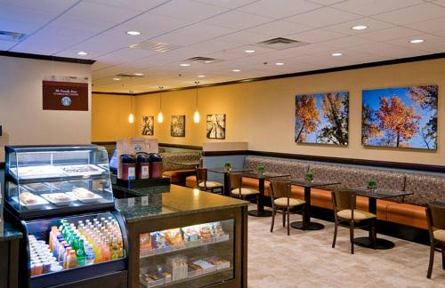 a fast food restaurant with tables and chairs at Wyndham Garden Oklahoma City Resort & Conference Hotel Near Airport, Fairgrounds Paycom & I40 in Oklahoma City