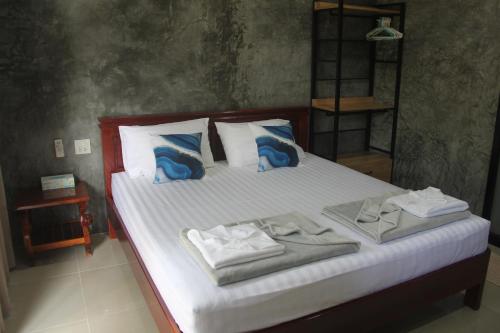 sypialnia z łóżkiem z ręcznikami w obiekcie Yangyai Garden Lodge w mieście Baan Tai