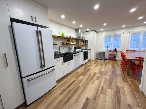 a kitchen with white appliances and a wooden floor at R18 Affordable Ski-in Ski-out Bretton Woods Townhome mountain views in Carroll