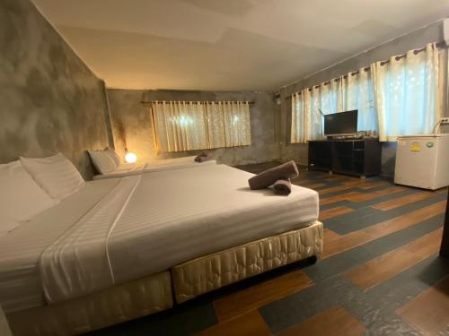 a bedroom with a large bed and a television at Crescent Bay Resort in Ko Samed