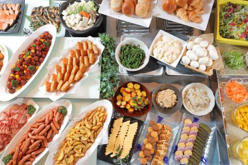 a table topped with lots of different types of food at Urban Hotel Kyoto Gojo Premium in Kyoto