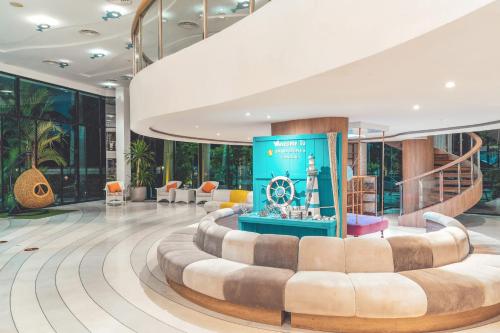 a lobby of a hotel with couches and chairs at Sand Dunes Chaolao Beach Resort in Chao Lao Beach
