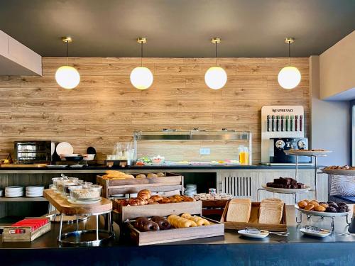 a bakery with many different types of bread and pastries at Hotel Acta Madfor in Madrid