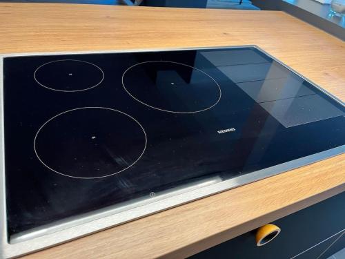 a stove top oven sitting on top of a wooden table at Inviting 4-Bed House in Berdorf Luxemburg in Berdorf