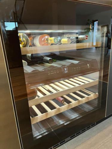 a refrigerator filled with lots of bottles of alcohol at Inviting 4-Bed House in Berdorf Luxemburg in Berdorf