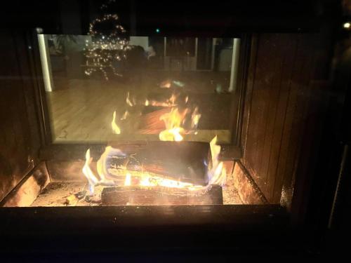 a fire in a brick oven with flames in it at Inviting 4-Bed House in Berdorf Luxemburg in Berdorf
