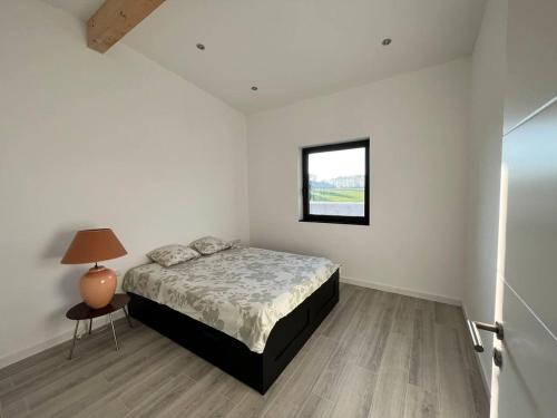 a bedroom with a bed and a small window at Inviting 4-Bed House in Berdorf Luxemburg in Berdorf