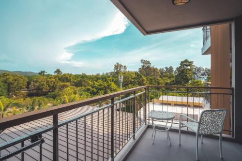a balcony with a table and chairs and a view at Sand Dunes Chaolao Beach Resort in Chao Lao Beach