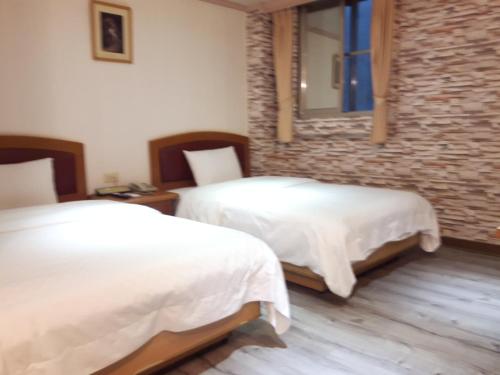 En eller flere senger på et rom på Lidu Hotel