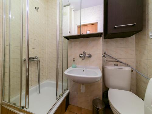a bathroom with a toilet and a sink and a shower at Sliska 10 apartament in Warsaw