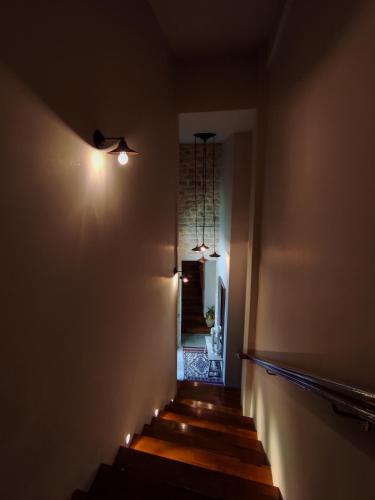 a hallway with a staircase with lights on the wall at Roptro in Doliana