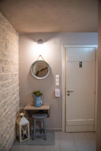 a hallway with a table and a mirror and a door at Roptro in Doliana