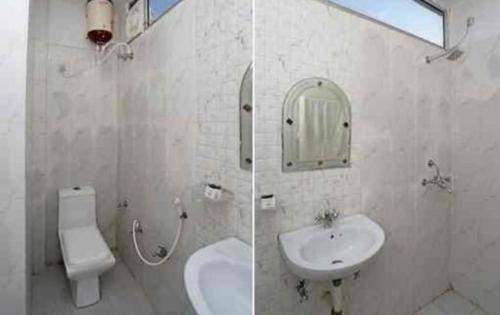 a bathroom with a sink and a toilet and a mirror at Hotel Gwal Palace By WB Inn in Agra