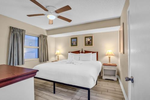 a bedroom with a bed and a ceiling fan at Stunning Views and Amazing Amenities in Atlantica in Myrtle Beach