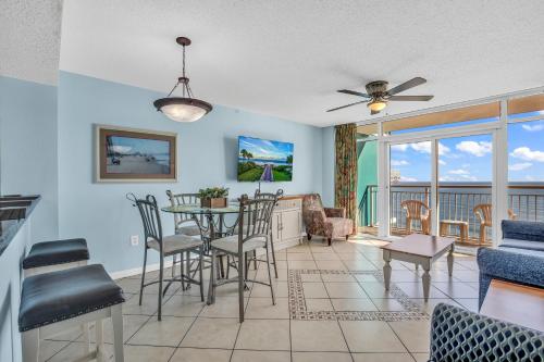 a dining room and living room with a table and chairs at Stunning Views and Amazing Amenities in Atlantica in Myrtle Beach