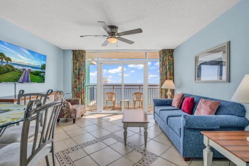 a living room with a blue couch and a table at Stunning Views and Amazing Amenities in Atlantica in Myrtle Beach