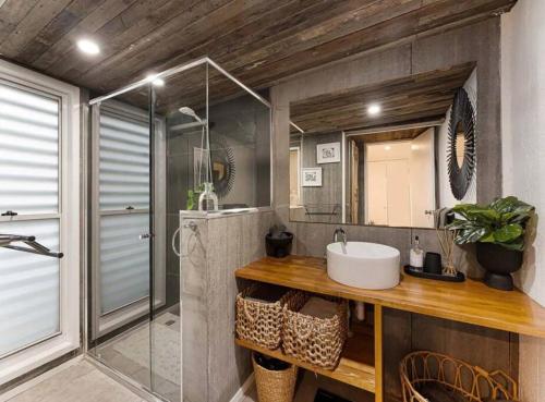 a bathroom with a sink and a shower at Sunset on Noosa Chalet in Noosa Heads