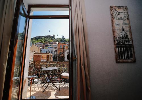 a view of a city from a balcony at Sharden Villa Boutique Hotel in Tbilisi City