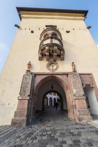 an entrance to a building with a clock on it at Apartmany Zechenterova in Kremnica