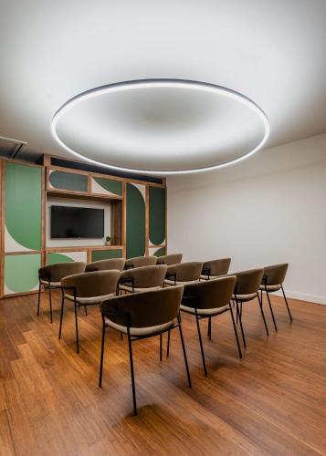 a conference room with chairs and a large white ceiling at Kimpton Aysla Mallorca by IHG in Santa Ponsa