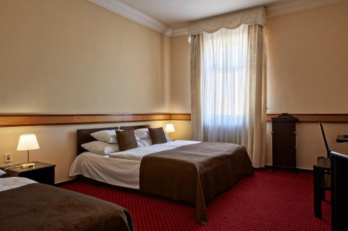 Postel nebo postele na pokoji v ubytování FLEUR DE LIS HOTEL