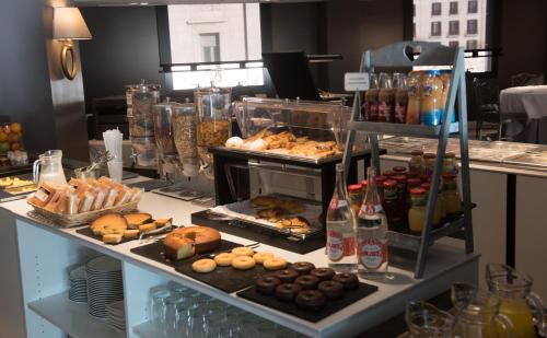 a buffet with many different types of pastries and drinks at Hotel Bahía in Santander