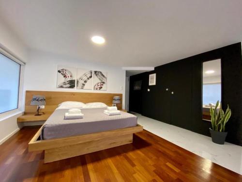 a bedroom with a bed and a large window at Mosaikon Guesthouses #Aiolou Str in Athens