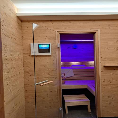 a sauna with purple lighting in a wooden room at Hittenpichl in Bodenmais