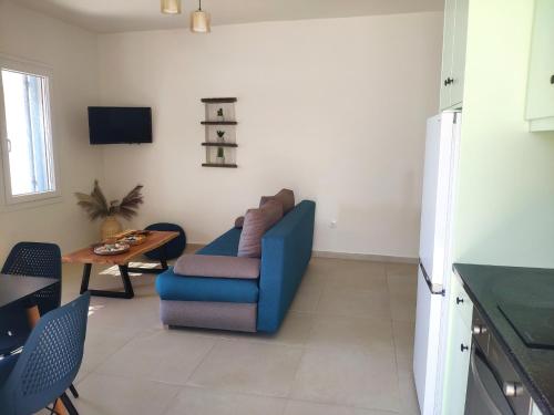 a living room with a blue couch and a table at Aelia Mare Apartments Nr4 in Istérnia