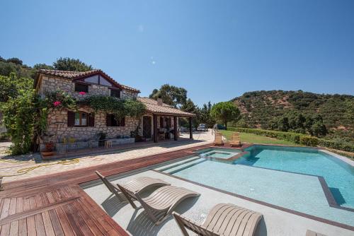 a villa with a swimming pool and a house at Wild Oak Estate - Stunning Views at a Dreamy Location, by ZanteWize in Argasi