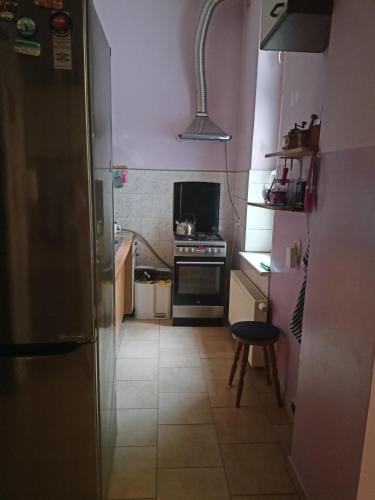 a small kitchen with a stove and a refrigerator at - PASTELOWY loft - in Sopot