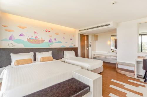 a hotel room with two beds and a bathroom at Sand Dunes Chaolao Beach Resort in Chao Lao Beach
