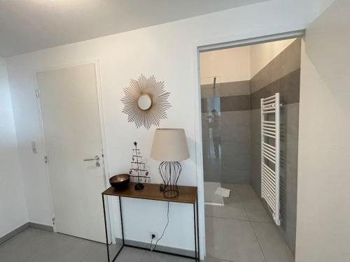 Pokój ze stołem z lampką i lustrem w obiekcie Ajaccio, les Cyclades, magnifique appartement vue mer w Ajaccio