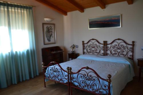 a bedroom with a bed with blue sheets and a window at B&B Spring in Perugia