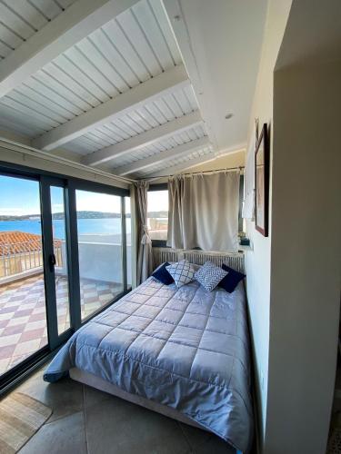 a bedroom with a bed with a view of the ocean at La Pausa in Porto Heli