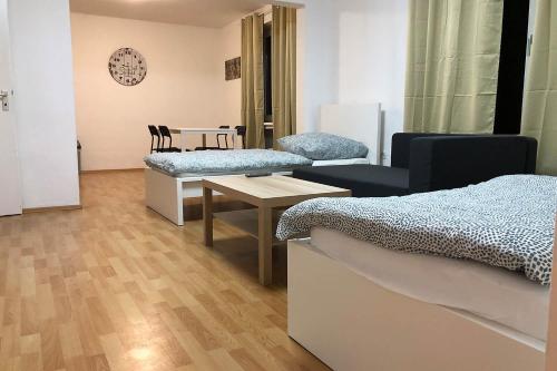 a room with two beds and a table with chairs at cozy Apartments with WiFi in Oberhausen