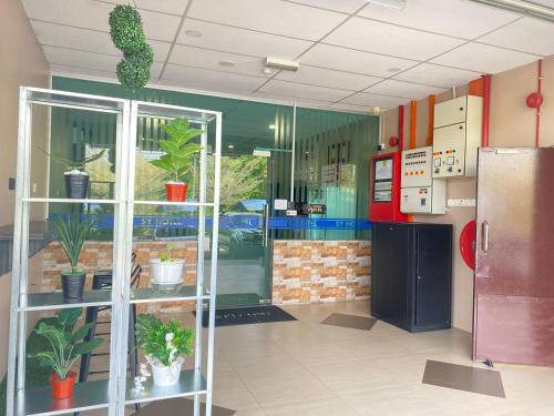 a room with a kitchen with potted plants in it at SY JERANTUT HOTEL in Jerantut